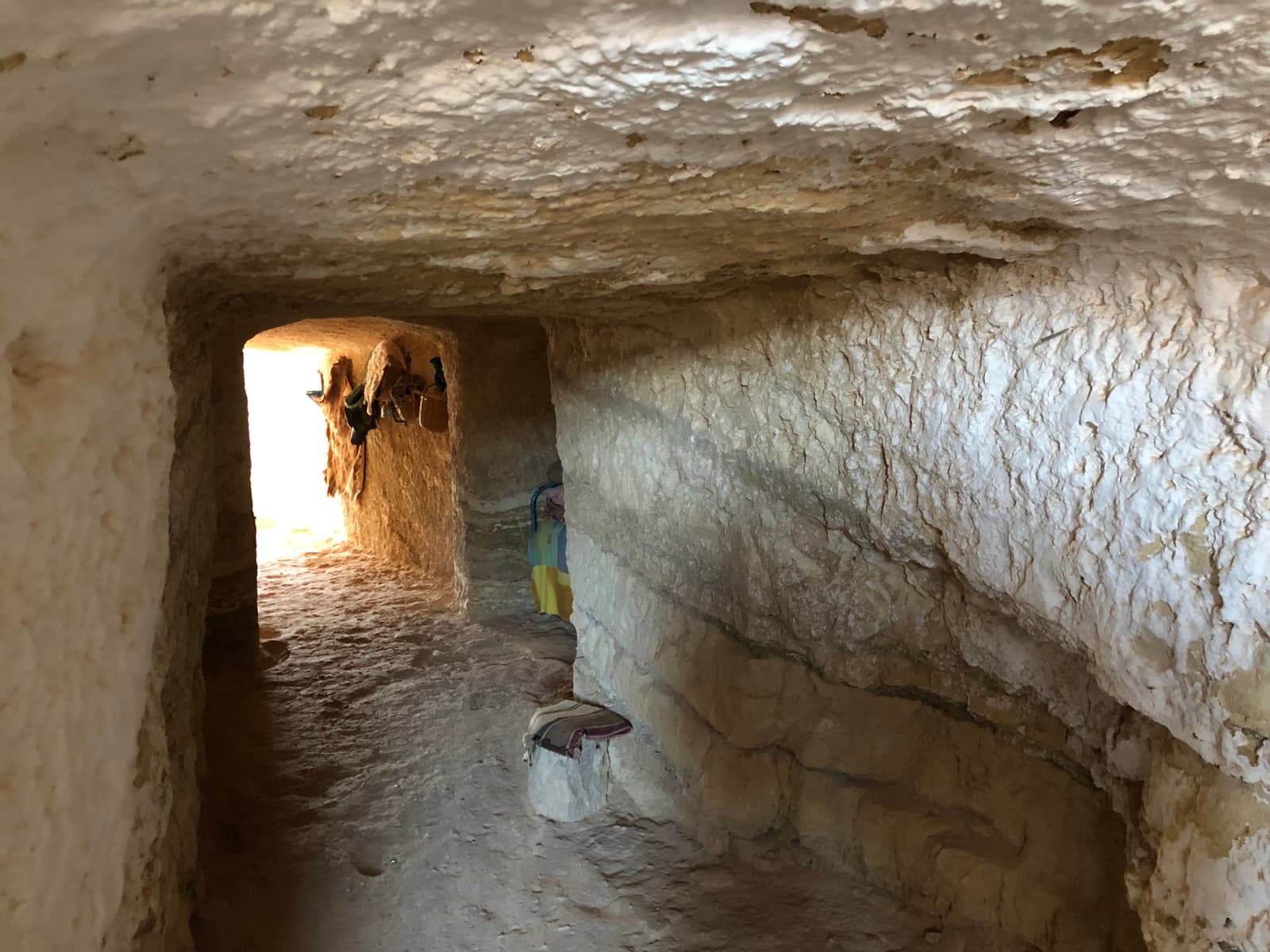 A whitewashed passage cut through the rock inside a troglodyte house in Matmata