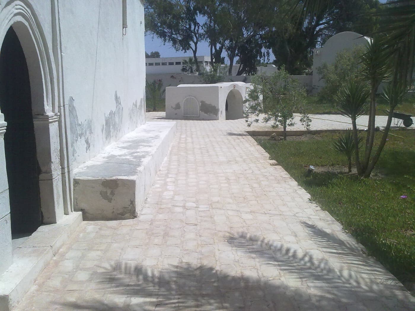 A whitewashed arcade and courtyard at a Djerba heritage museum