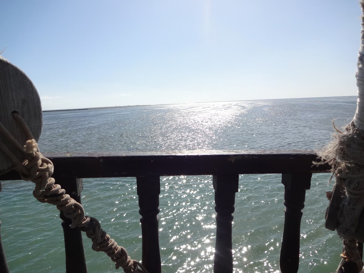The sea off Djerba seen past the wooden rail of an excursion boat